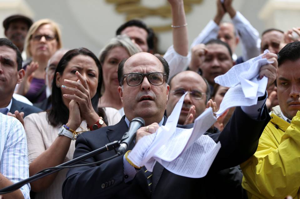 Julio Borges, President of the National Assembly, tears up a copy of a ruling by Venezuela's Supreme Court at a news conference in Caracas on Thursday.