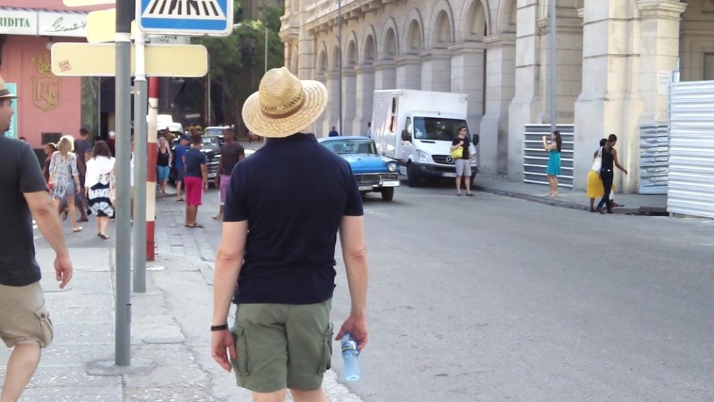 A tourist walks along Calle Monserrate, in Old Havana
